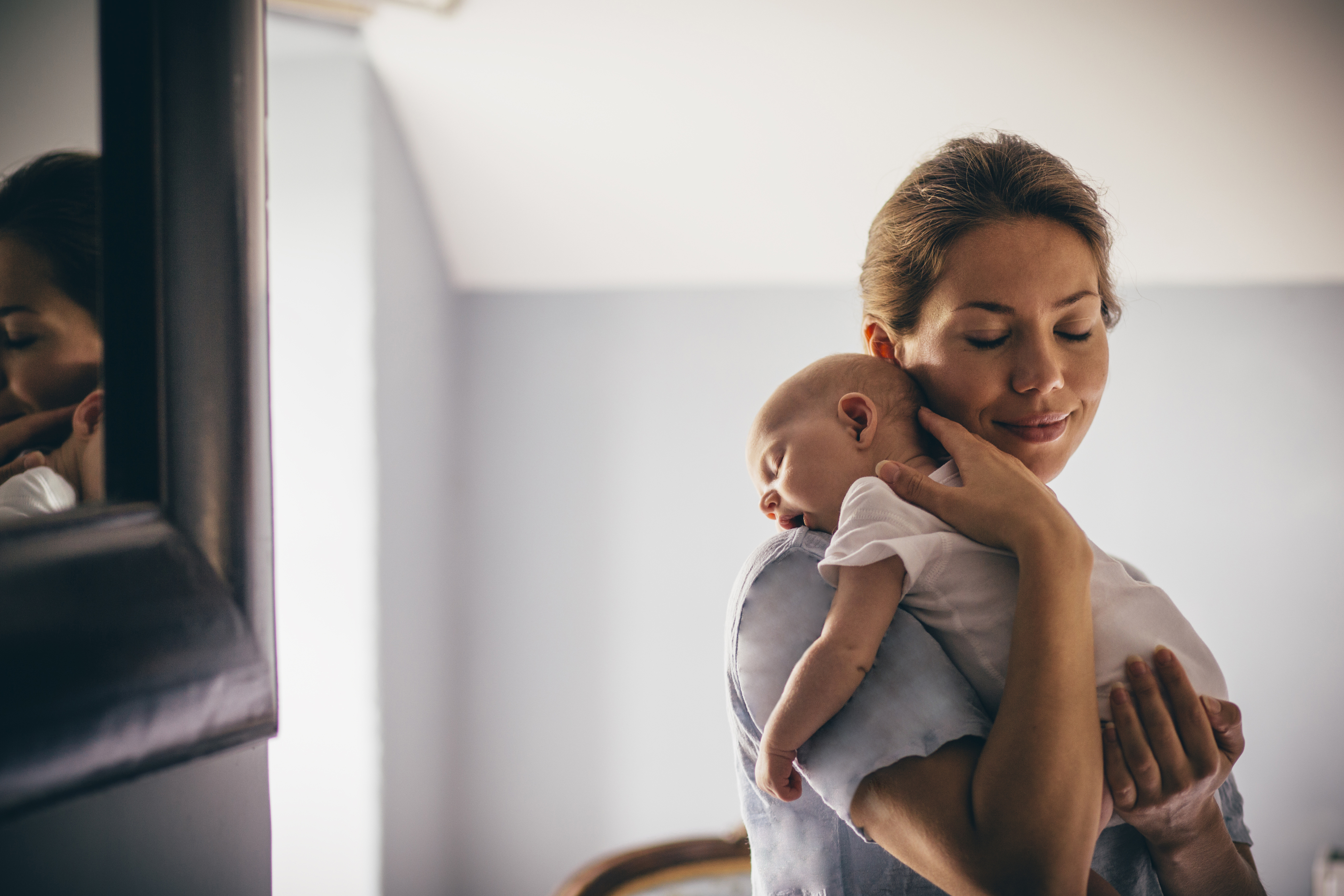 newborn baby napping on mother's shoulder, new mum, newborn baby