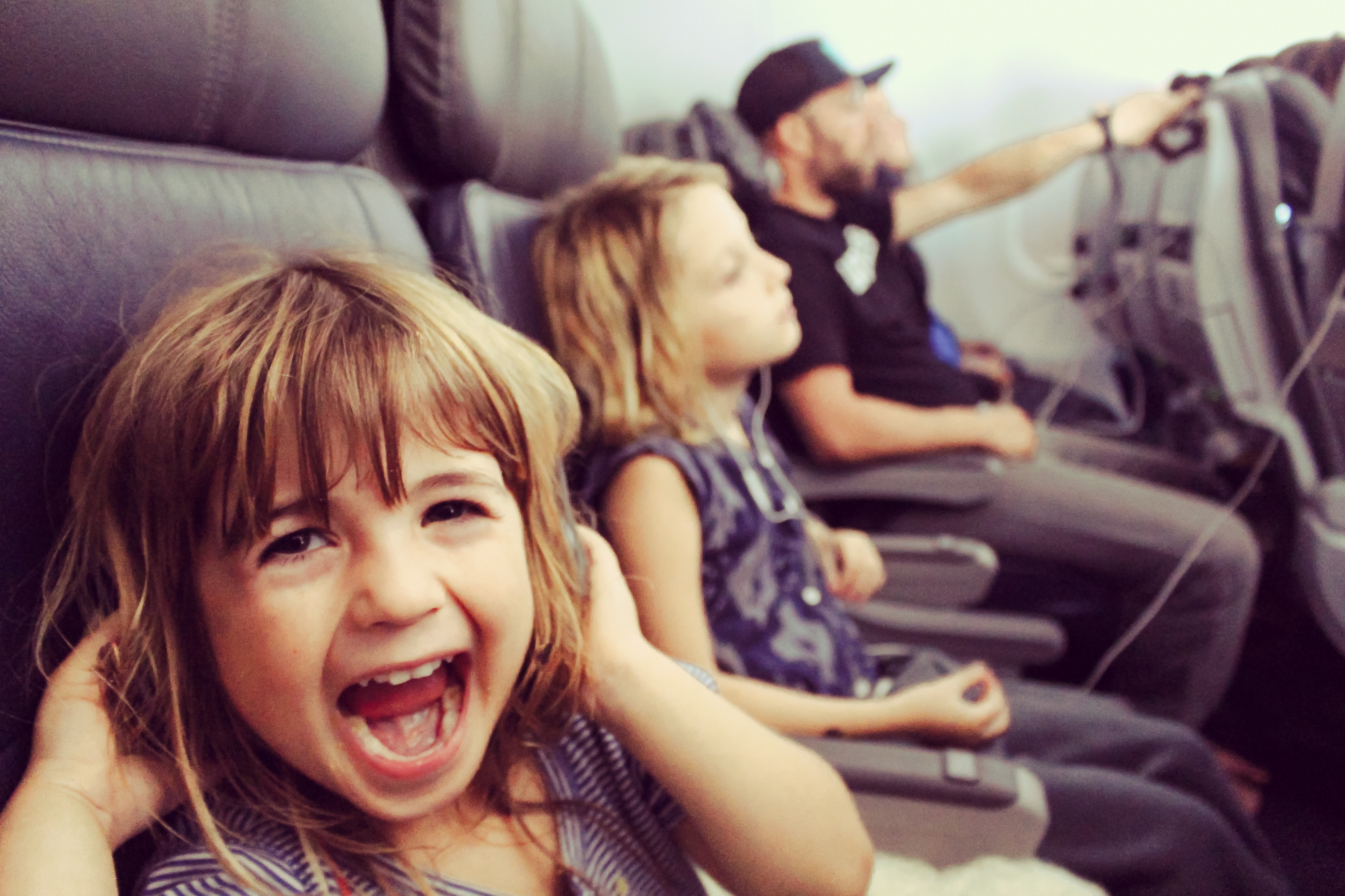 kids on a plane excited to go on holiday