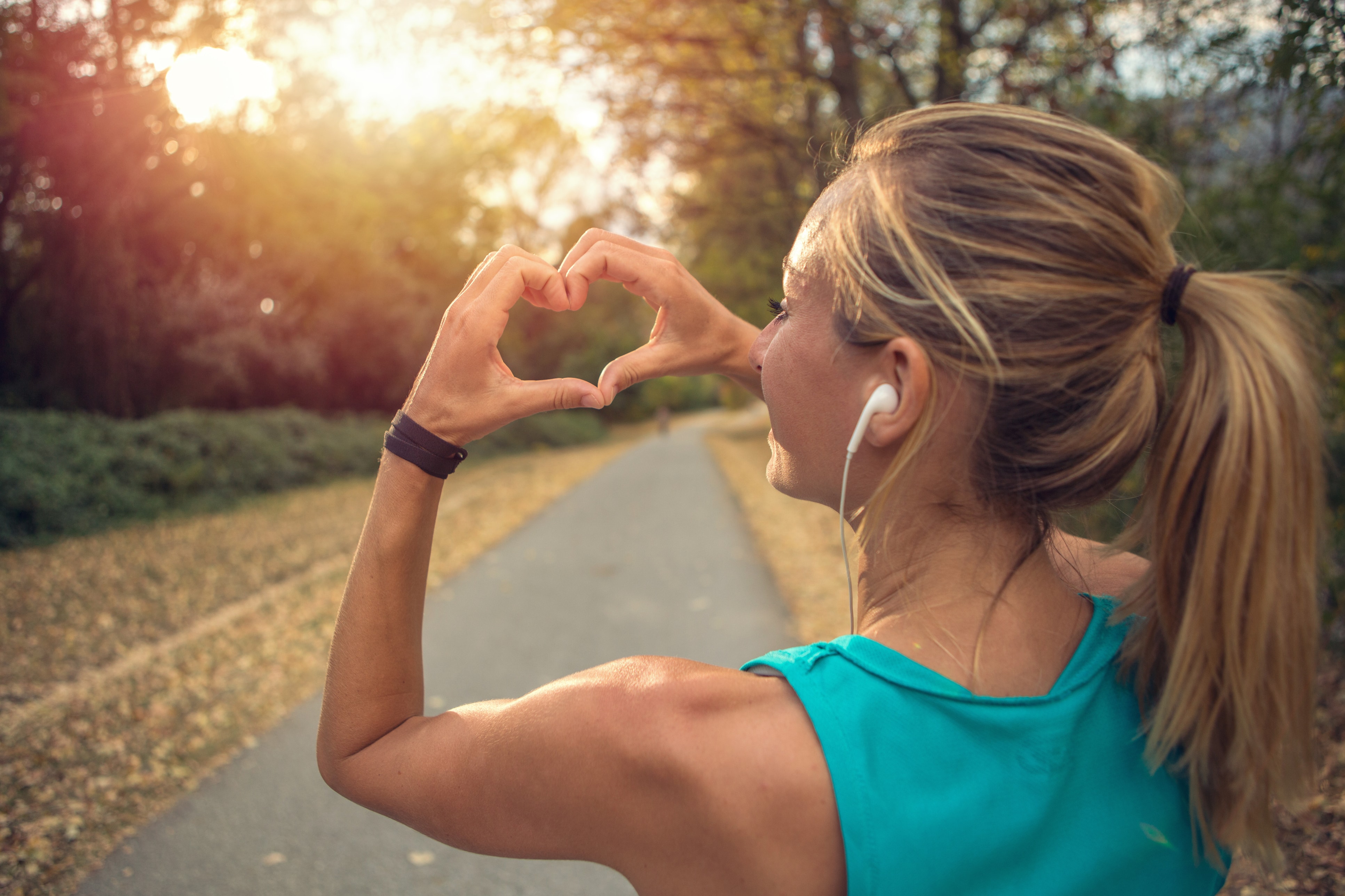 young woman exercising outdoors with a healthy heart