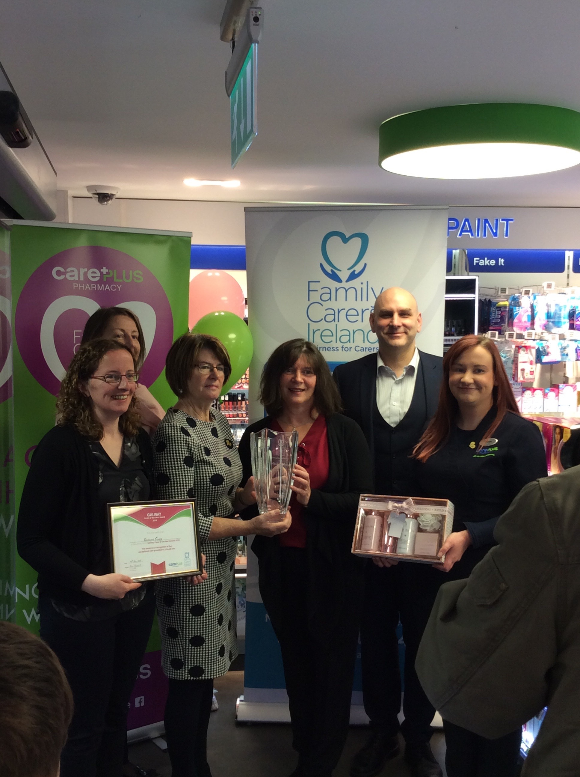 Pharmacist Eoghan Hanley and Staff presenting Adrienne with her award.