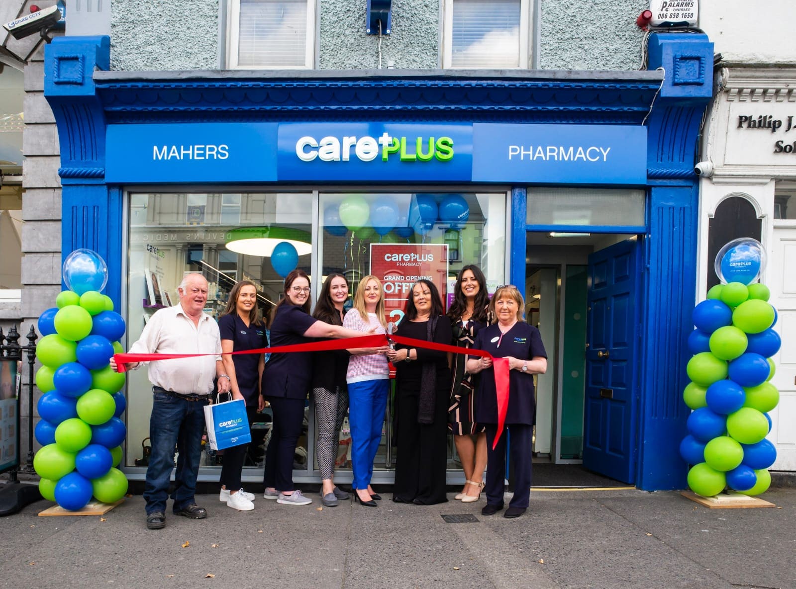 Mahers staff cutting the ribbon